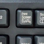 A black key, on it, in white: the phrase "print screen" a horizontal line and the word "SysRq."