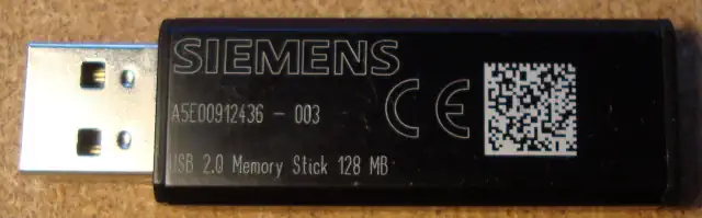 A black plastic electronic device with a USB plug sticking out of it. Printed in white: SIEMENS A5E00912436 - 003 CE USB 2.0 Memory Stick 128 MB.