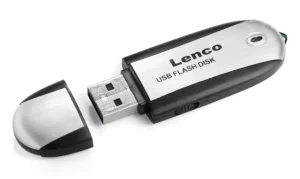A small black and white electronic device with a USB plug sticking out of it. Text in black reads Lenco USB FLASH DISK.